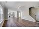 Open living room with hardwood floors, kitchen and staircase views at 5107 Lakeview Rd, Charlotte, NC 28216