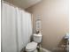 Clean bathroom with white toilet and shower, and a decorative wall hanging at 517 Fenton Pl, Rock Hill, SC 29732