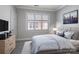 Bright bedroom with a comfy bed, dresser, and large window at 5617 Fairview Rd # 9, Charlotte, NC 28209