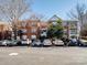 Charming three-story brick apartment building with ample parking on a sunny day at 5617 Fairview Rd # 9, Charlotte, NC 28209