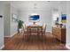 Inviting dining area with modern chandelier, stylish decor, and wood flooring; perfect for entertaining at 5617 Fairview Rd # 9, Charlotte, NC 28209