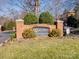 Community entrance sign with landscaping and brick pillars at 5617 Fairview Rd # 9, Charlotte, NC 28209