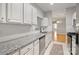 Bright kitchen featuring white cabinets and granite countertops at 5617 Fairview Rd # 9, Charlotte, NC 28209