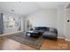 Bright living room featuring vaulted ceilings, sliding glass doors, and a comfortable gray sofa at 5617 Fairview Rd # 9, Charlotte, NC 28209