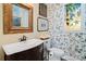 Charming bathroom with bird wallpaper and stained glass window at 5915 Quail Hollow Rd # E, Charlotte, NC 28210