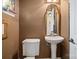 Small powder room with pedestal sink and toilet at 5915 Quail Hollow Rd # E, Charlotte, NC 28210