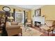 Cozy living room features a fireplace and hardwood floors at 5915 Quail Hollow Rd # E, Charlotte, NC 28210