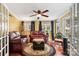 Relaxing sunroom with leather furniture and ceiling fan at 5915 Quail Hollow Rd # E, Charlotte, NC 28210