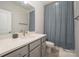 Clean bathroom with gray vanity, white quartz countertop and a shower/tub combo at 6027 Towering Oaks Dr, Charlotte, NC 28205