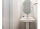 Small bathroom with pedestal sink and oval mirror at 6027 Towering Oaks Dr, Charlotte, NC 28205