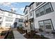 Modern townhome with gray and white exterior, brick accents, and a charming walkway at 6027 Towering Oaks Dr, Charlotte, NC 28205