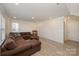 Open living room with a brown sectional sofa and wood accent table at 6027 Towering Oaks Dr, Charlotte, NC 28205