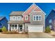 Two-story house with gray siding, red accents, and a two-car garage at 6265 Six String Ct, Fort Mill, SC 29708