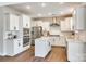 Modern kitchen with white cabinets, island, and stainless steel appliances at 6265 Six String Ct, Fort Mill, SC 29708