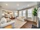 Open living room with a view into the kitchen and fireplace at 6265 Six String Ct, Fort Mill, SC 29708