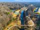 Aerial view showing community amenities including a creek, walking trails, and tennis courts at 6417 Union Station Ct, Charlotte, NC 28210