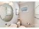 Clean bathroom with an oval mirror and updated fixtures at 6417 Union Station Ct, Charlotte, NC 28210