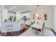 Bright dining area with a white table and four chairs, near the kitchen at 6417 Union Station Ct, Charlotte, NC 28210