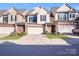 Modern two-story townhome with attached garage and well-manicured landscaping at 6417 Union Station Ct, Charlotte, NC 28210