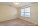 Simple bedroom with neutral walls, carpet, and a large window at 6808 Cascade Dream Ct # 118, Huntersville, NC 28078