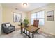 Spacious bedroom with a large window and stylish workspace setup at 6808 Cascade Dream Ct # 118, Huntersville, NC 28078