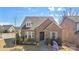 Aerial view of a charming brick home with a well-manicured lawn at 703 Marion Dr, Matthews, NC 28105