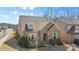 Aerial view of a charming brick home with a well-manicured lawn at 703 Marion Dr, Matthews, NC 28105