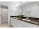 Modern bathroom with double vanity, dark countertop, and shower at 703 Marion Dr, Matthews, NC 28105