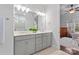 Modern bathroom with double vanity and view of bedroom at 703 Marion Dr, Matthews, NC 28105