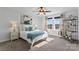 Bright bedroom with a queen bed, ceiling fan, and ample natural light at 703 Marion Dr, Matthews, NC 28105