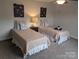 Two twin beds in a well-lit bedroom with neutral decor at 703 Marion Dr, Matthews, NC 28105