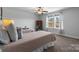 Well-lit bedroom with two twin beds, ample natural light, and a ceiling fan at 703 Marion Dr, Matthews, NC 28105