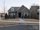 Brick home with front porch and landscaped yard at 703 Marion Dr, Matthews, NC 28105