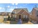 Brick house with a landscaped yard and welcoming front porch at 703 Marion Dr, Matthews, NC 28105