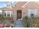 Brick home with gray door, landscaping, and walkway at 703 Marion Dr, Matthews, NC 28105