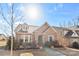 Brick house with landscaping, walkway, and two-car garage at 703 Marion Dr, Matthews, NC 28105