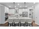 Modern kitchen with white cabinets, granite counters, and island at 703 Marion Dr, Matthews, NC 28105