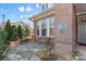 Stone patio with bench and potted plants next to house at 703 Marion Dr, Matthews, NC 28105