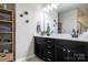 Double vanity bathroom with modern dark cabinets and quartz countertop at 7216 Somerford Rd, Charlotte, NC 28215