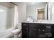 Clean bathroom with dark vanity, shower, and bathtub at 7216 Somerford Rd, Charlotte, NC 28215