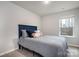 Bright bedroom with a blue headboard and gray bedding at 7216 Somerford Rd, Charlotte, NC 28215