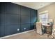 Cozy home office features a dark blue accent wall, wood desk, and window at 7216 Somerford Rd, Charlotte, NC 28215