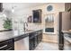 Modern kitchen with dark cabinets, granite countertops, and stainless steel appliances at 7216 Somerford Rd, Charlotte, NC 28215