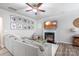 Living room with fireplace, sectional sofa, and gallery wall at 7216 Somerford Rd, Charlotte, NC 28215