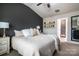 Main bedroom with a dark accent wall and ensuite bathroom access at 7216 Somerford Rd, Charlotte, NC 28215