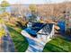 Lakefront home with circular driveway and detached garage, offering serene waterfront views at 7476 Point St, Denver, NC 28037