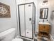 Modern bathroom with a frameless glass shower and a stylish wood vanity at 7476 Point St, Denver, NC 28037