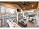 Relaxing covered porch overlooking the lake with wicker furniture at 7476 Point St, Denver, NC 28037