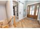 Elegant entryway with hardwood floors, a barn door, and laundry access at 7476 Point St, Denver, NC 28037