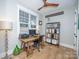 Functional home office with a rustic desk, shelving, and ample natural light at 7476 Point St, Denver, NC 28037